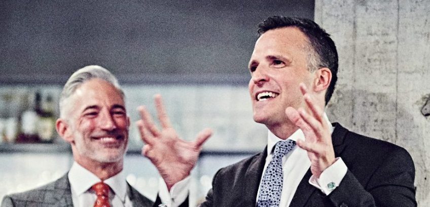 Gifford gives a speech while partner DeVincent looks on. Photo by Peter Brinch